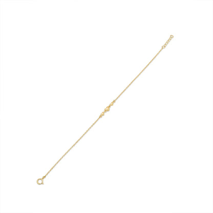 Close view of the three gold heart charms on the bracelet