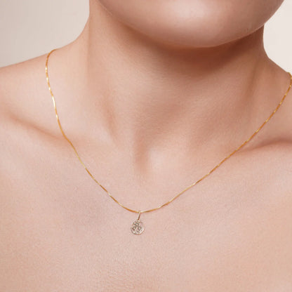 14 karat gold sunflower pendant shown on a chain